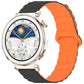 Orange and black magnetic silicone band on a round smartwatch with a gold-tone case