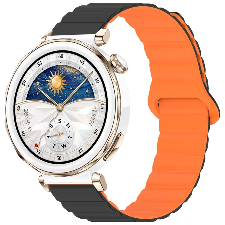 Orange and black magnetic silicone band on a round smartwatch with a gold-tone case