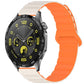 Silicone watch band in ivory and orange with a magnetic loop closure, shown on a watch.