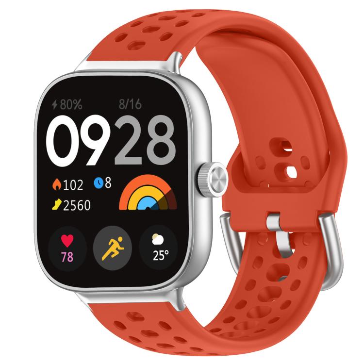 Red perforated silicone sport watch band with silver buckle on a smartwatch