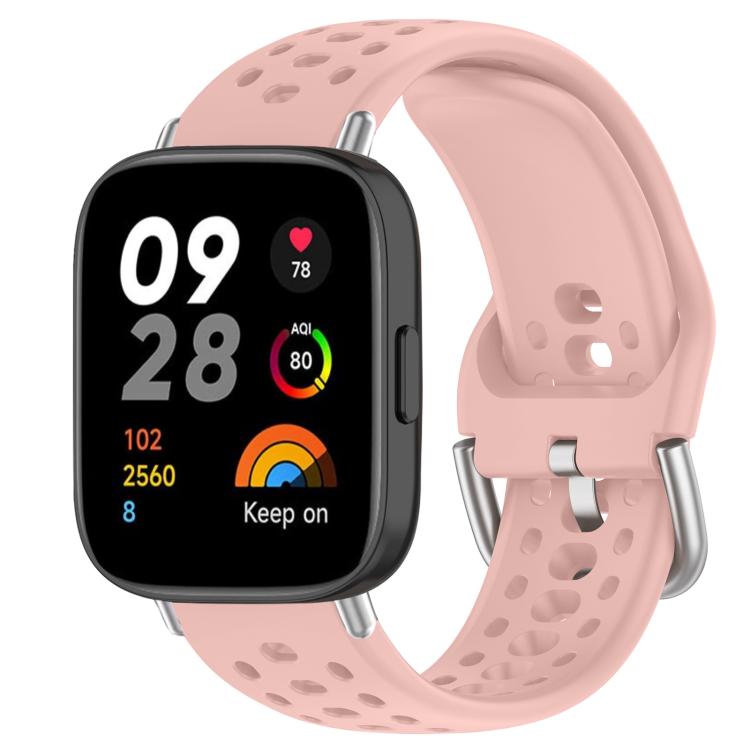 Pink perforated silicone sport watch band with silver buckle on a black smartwatch