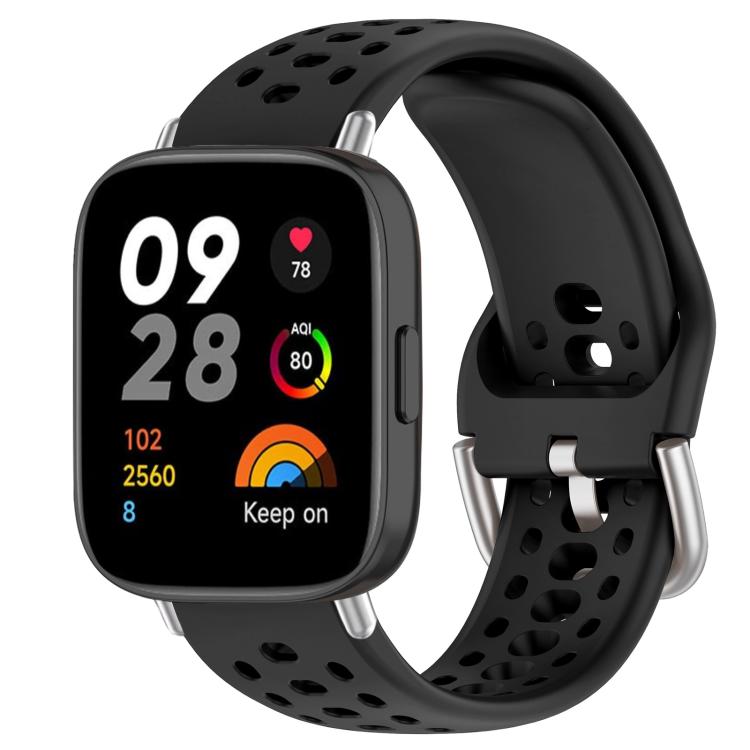 Black perforated silicone sport watch band with silver buckle on a black smartwatch
