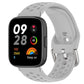Gray perforated silicone sport watch band with silver buckle on a black smartwatch