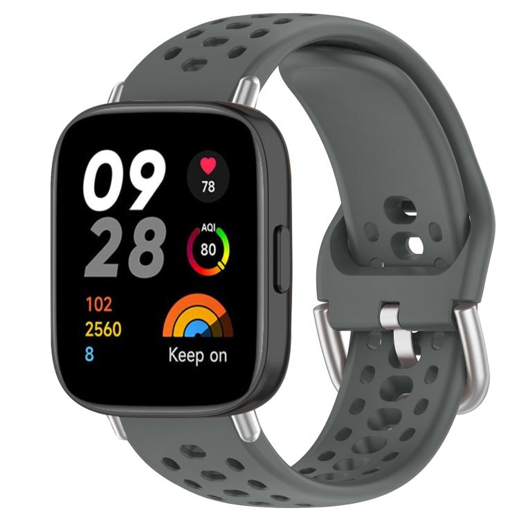 Dark gray perforated silicone sport watch band with silver buckle on a black smartwatch