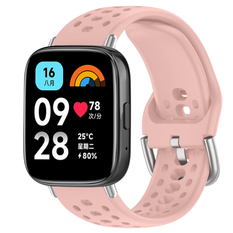 Light pink perforated silicone sport watch band with silver buckle, shown on a smartwatch