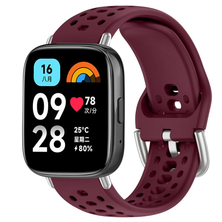 Wine red perforated silicone sport watch band with silver buckle, shown on a smartwatch