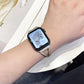 Silver crystal-accented stainless steel watch band worn on a wrist.