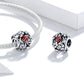 Charm bead on silver chain with red ladybug enamel and flower filigree.