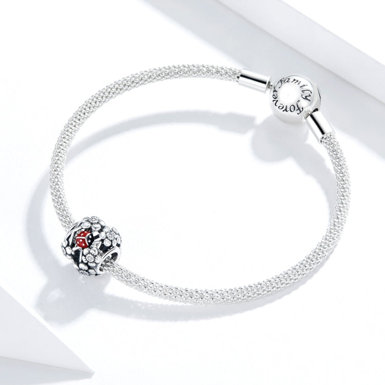 Silver charm bracelet with S925 ladybug filigree bead featuring red enamel.