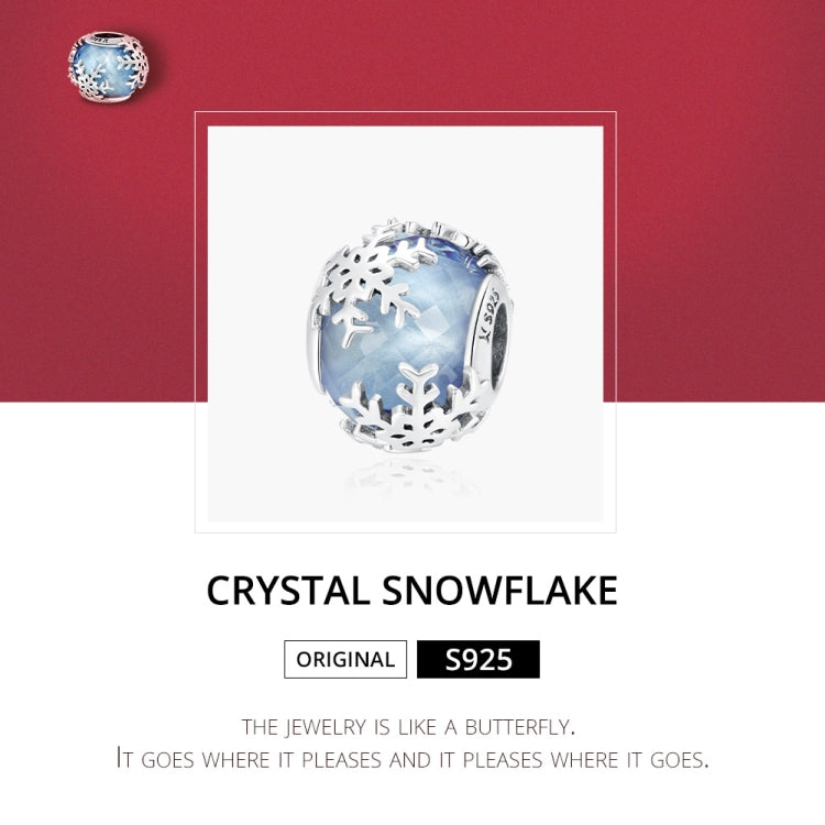 Sterling silver snowflake charm bead with blue translucent glass and engraved snowflake motifs