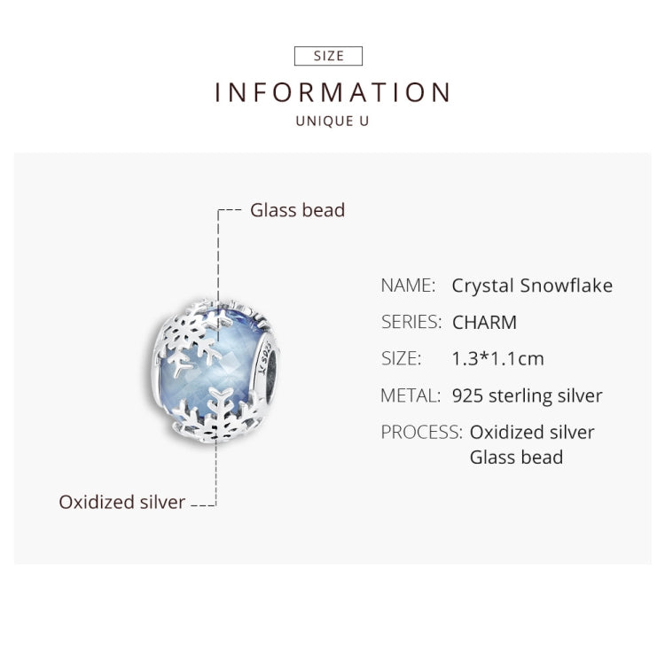 Blue glass snowflake charm bead surrounded by oxidized sterling silver snowflake cutouts
