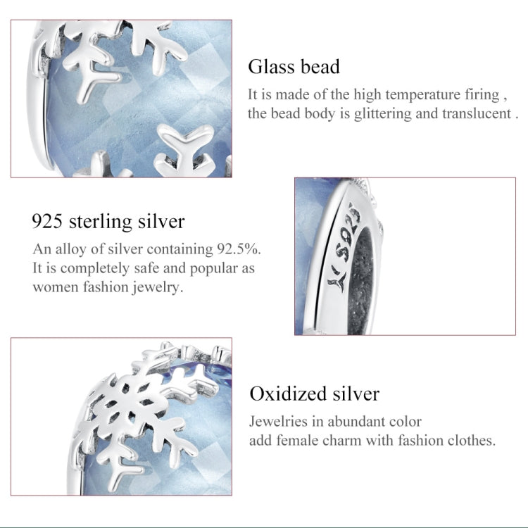 Close-up of blue glass snowflake charm bead with silver frame and cutout snowflake shapes