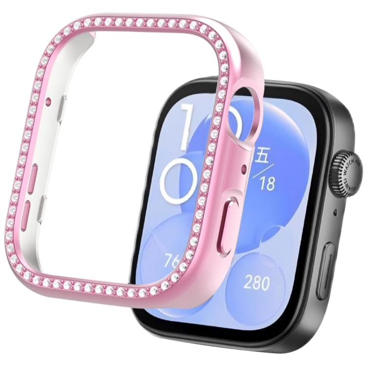Pink smartwatch protective cover with crystal trim beside a watch