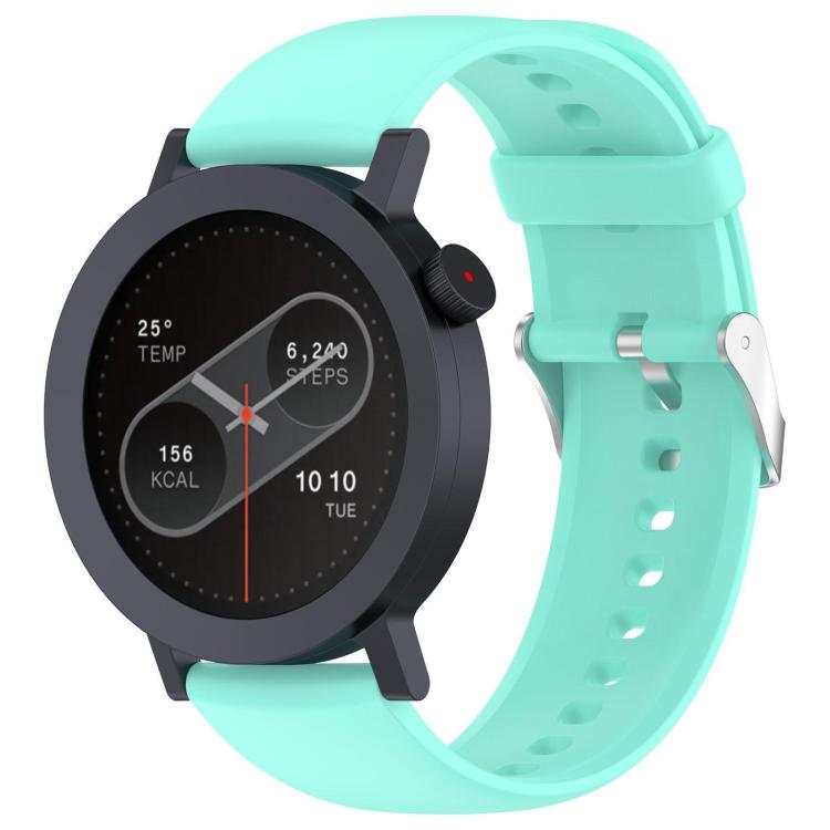 Teal silicone watch band fitted to a round smartwatch, with adjustment holes and metal buckle.