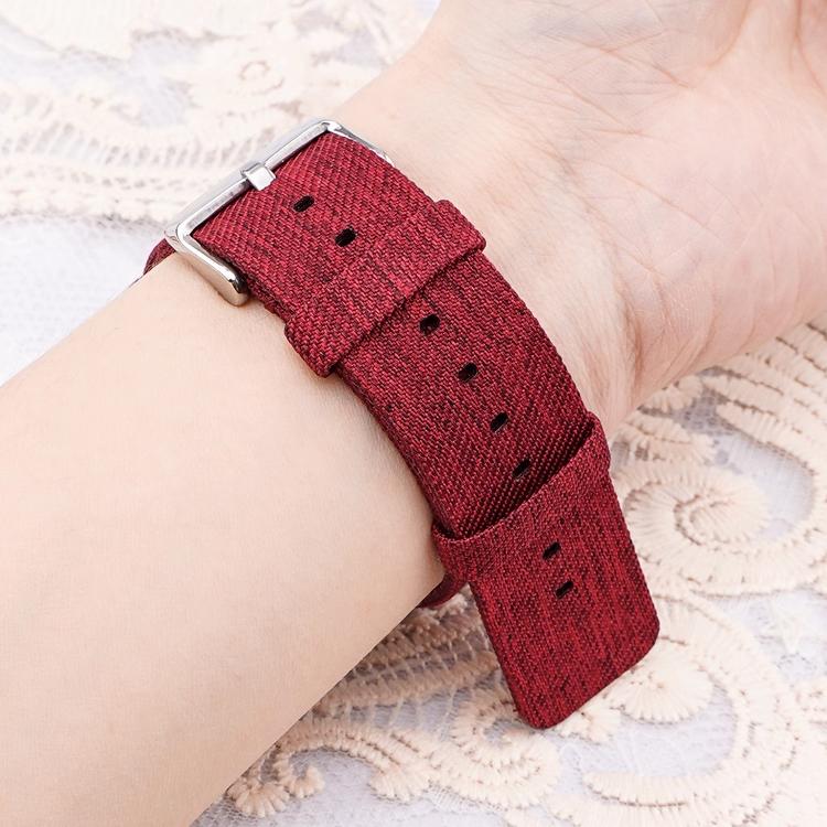 Red woven nylon watch band with silver buckle, shown fastened around a wrist