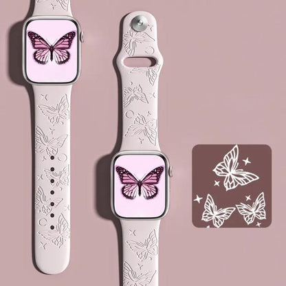 xDfind pale pink silicone watch band with engraved butterflies, shown on an Apple Watch