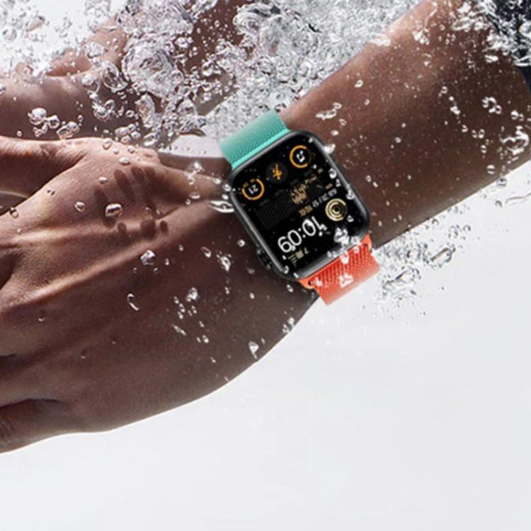 Milanese watch band with teal and orange sections, worn on a wrist
