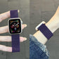 Purple Milanese stainless steel watch band shown held upright and worn on a wrist