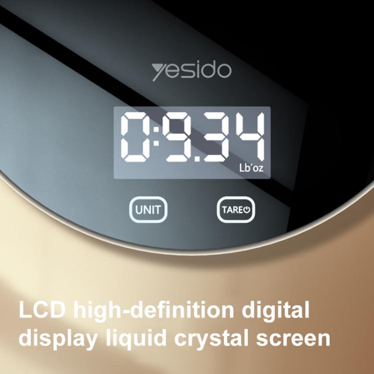 Close-up of black scale with digital LCD display showing weight and two control buttons