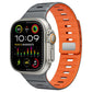 xDfind silicone Apple Watch band in dark gray and orange, with a Norman buckle.