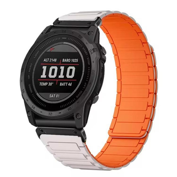 Garmin watch with a segmented silicone band, orange outer links and pale connector links.
