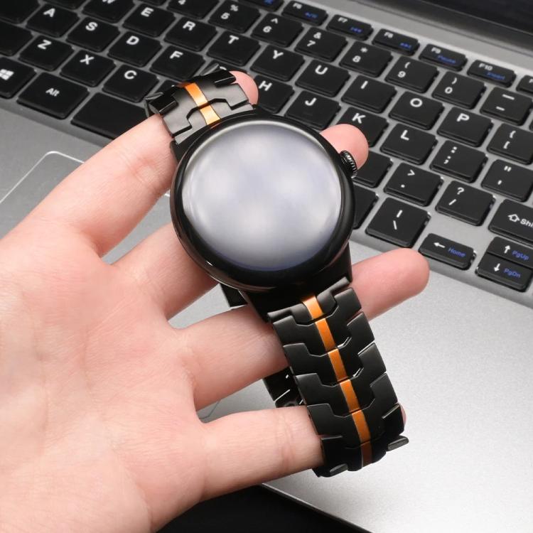 Black metal-link watch band with orange center stripe fitted to a smartwatch.