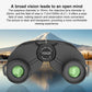 Black binoculars with green eyepiece lenses and central hinge, front view