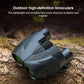 Black binoculars with textured grip and green eyepiece lenses, three-quarter view