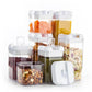 Food storage container set with multiple clear jars and white lids, filled with snacks and pasta