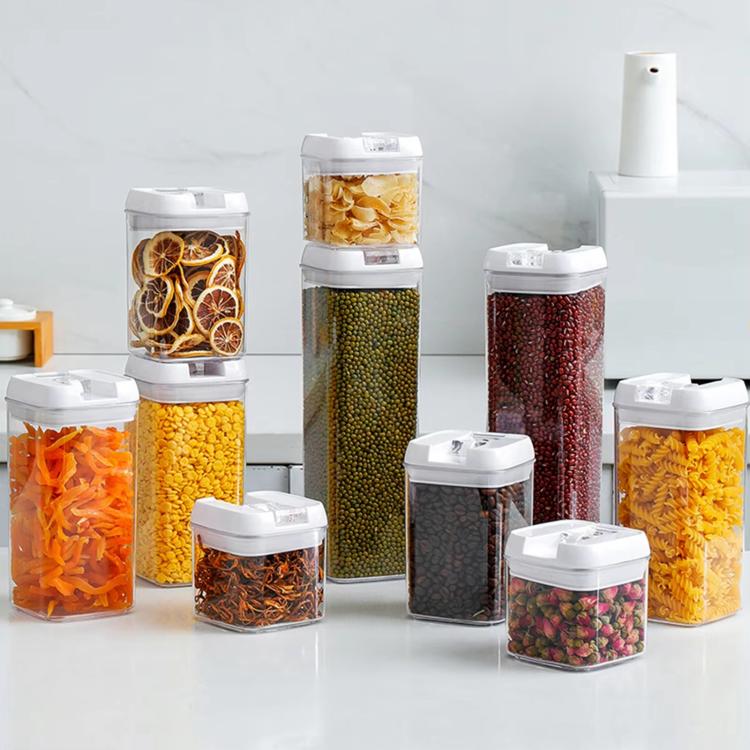 Food storage container set of multiple clear jars with white lids, filled with assorted dried foods