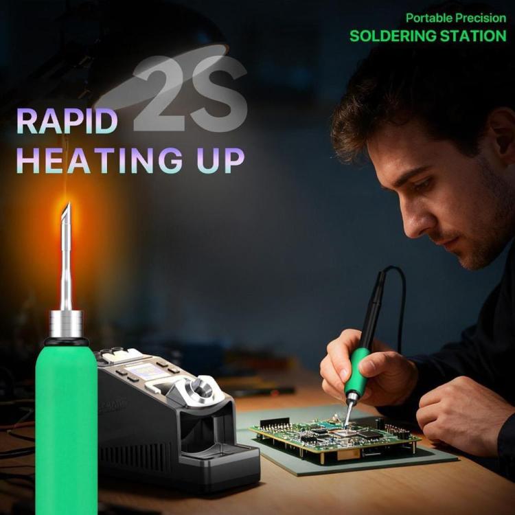 Handheld soldering with green-tipped iron on a circuit board and station base