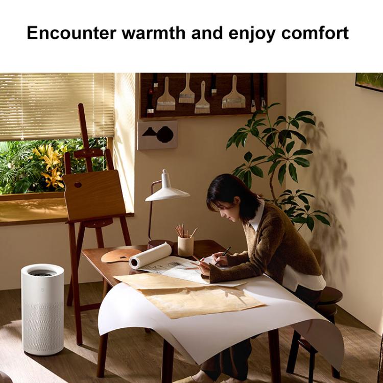 White no-mist humidifier on a floor, cylindrical body with perforated sides