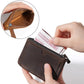 Dark leather coin purse wallet held in hand, zipper opening with card inside