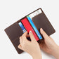 Genuine leather passport card holder wallet open with cards and a hand inserting items.