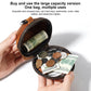 Black cap-style coin purse open with zipper, holding mixed coins and cash