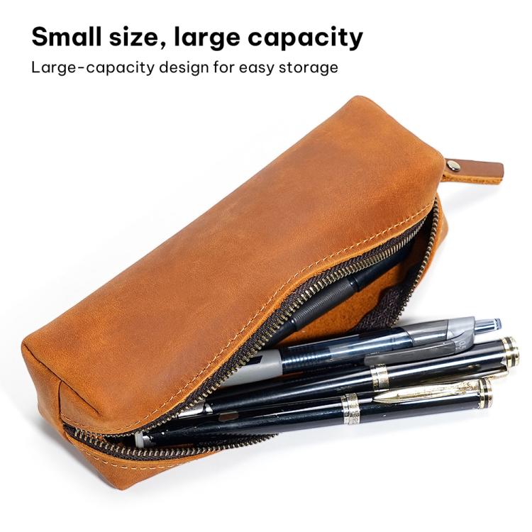 Brown leather pencil case open with zipper, holding pens