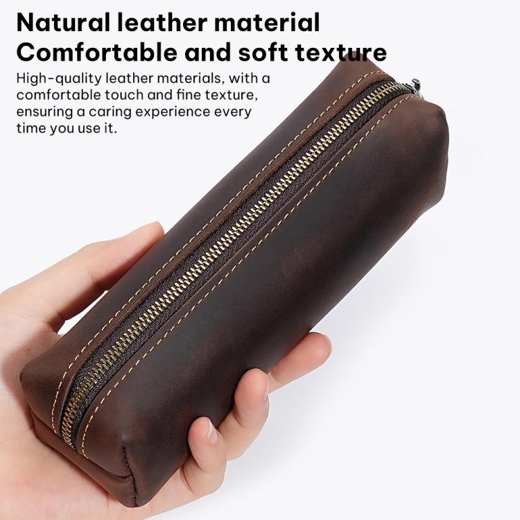 Brown leather pencil case held in hand with zipper and stitched trim