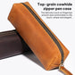 Brown leather zippered pencil case with metal zipper and stitched edges, angled view