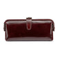 Coffee brown leather toiletry bag with top zipper, loop handle, and side tassel pulls
