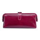 Wine red leather toiletry bag with top zipper, loop handle, and side tassel pulls