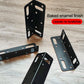 Set of black L-shaped corner brackets with slot cutouts and round mounting holes