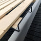 Black anti-slip guardrail strip secured along bed edge, gripping under base