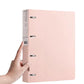A4 four-hole binder folder, light pink, hand holding the spine with 4 rings
