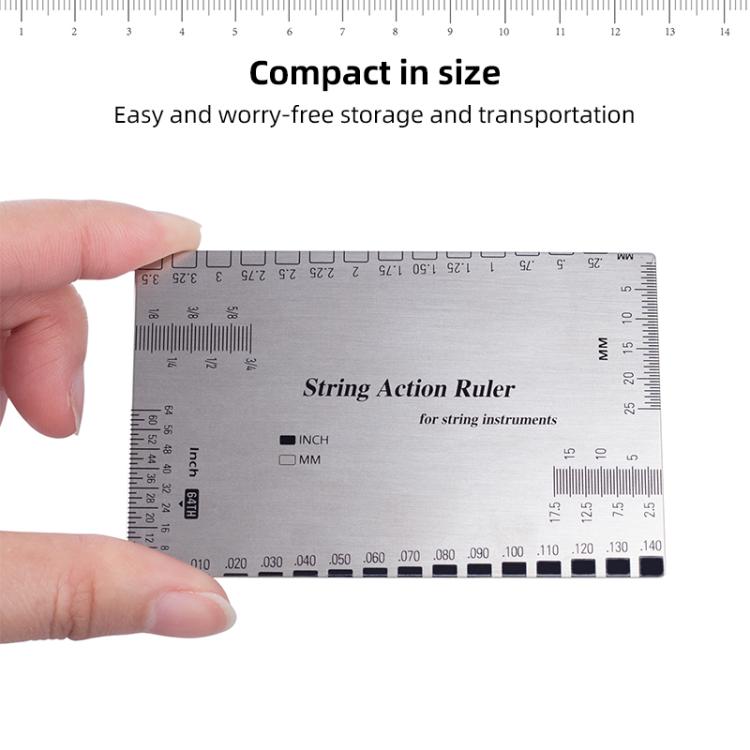 Guitar string action ruler gauge held in hand, showing inch/mm scale and rows