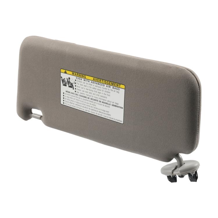 Gray right car sun visor with warning label and rear mounting brackets