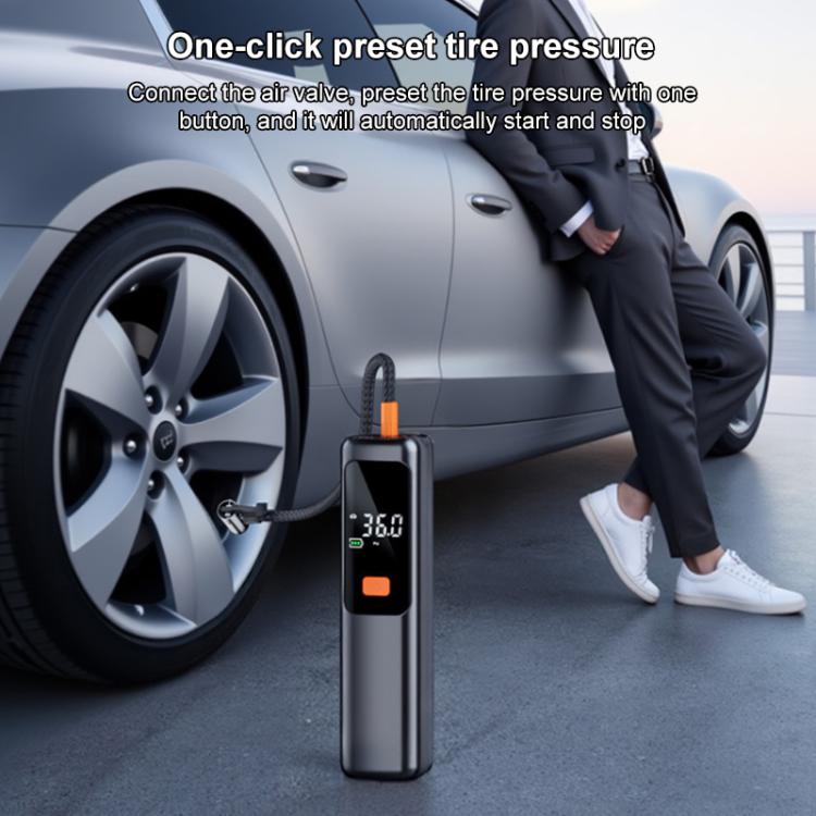 Black digital tire inflator at car wheel with orange button and pressure screen