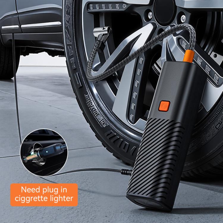 Wired car inflator pump near car wheel, hose routed from tire