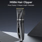 Black hair clipper with gold blade, side view, ergonomic grip and power button.