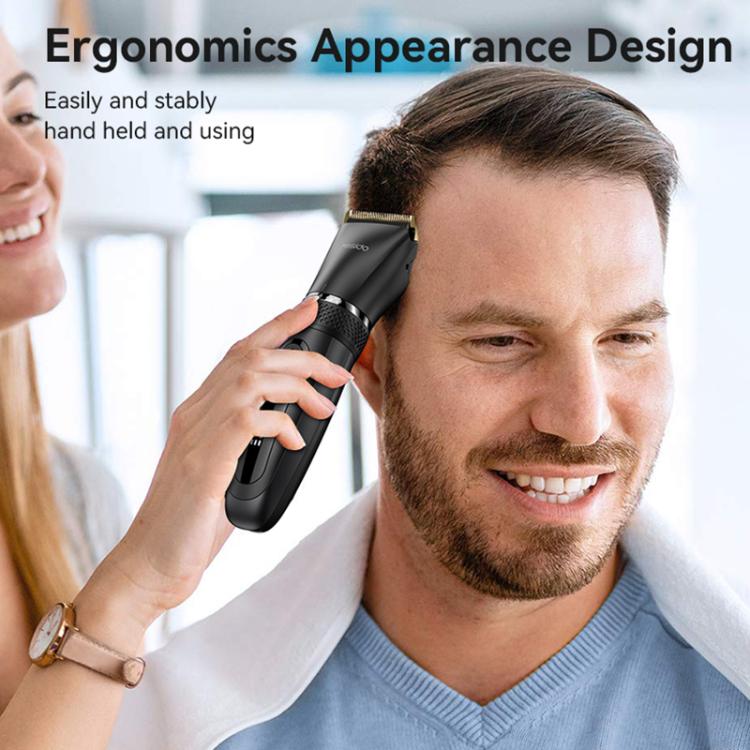 Black cordless hair clipper held near hair, gold blade visible on top.