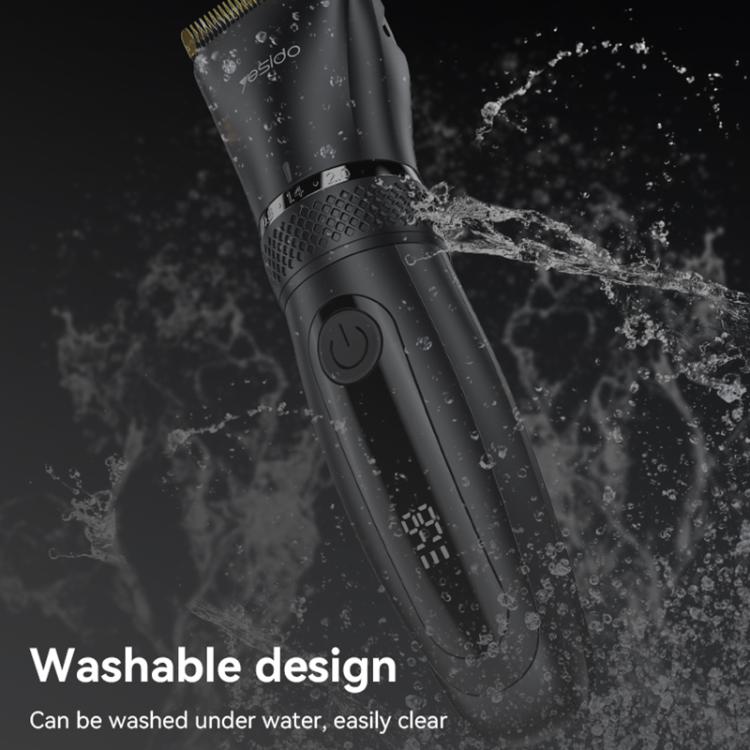 Black washable cordless hair clipper with gold blade, water droplets on body.